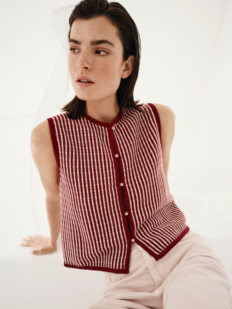 Woman in IReland wearing red waistcoat in two tone stripe with a beige cotton trouser