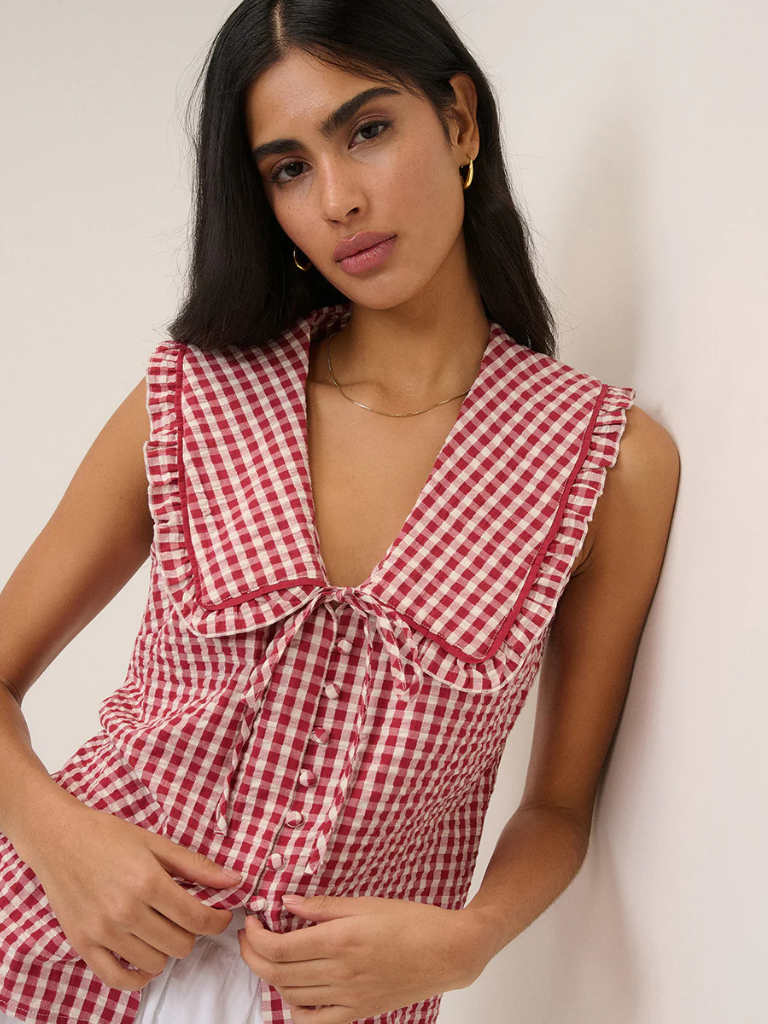 Woman in Ireland wearing a gingham blouse with collar detail and white jeans