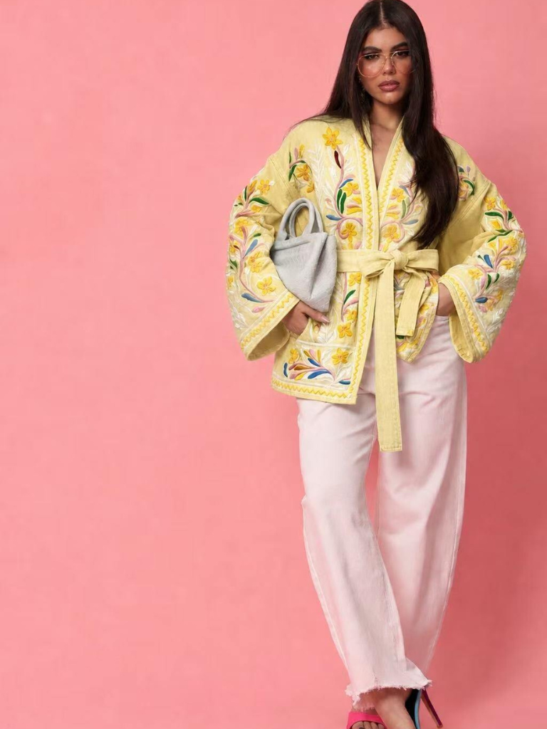Woman in Ireland wearing a yellow embroidered kimono and linen trousers and heels