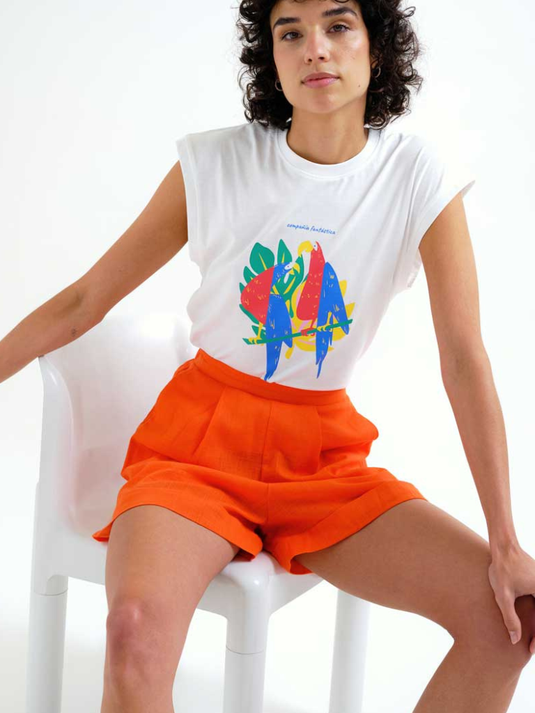 Woman in Ireland wearing Compania Fantastica cotton graphic t-shirt with colourful print and linen highwaisted shorts with pockets and pleating detail