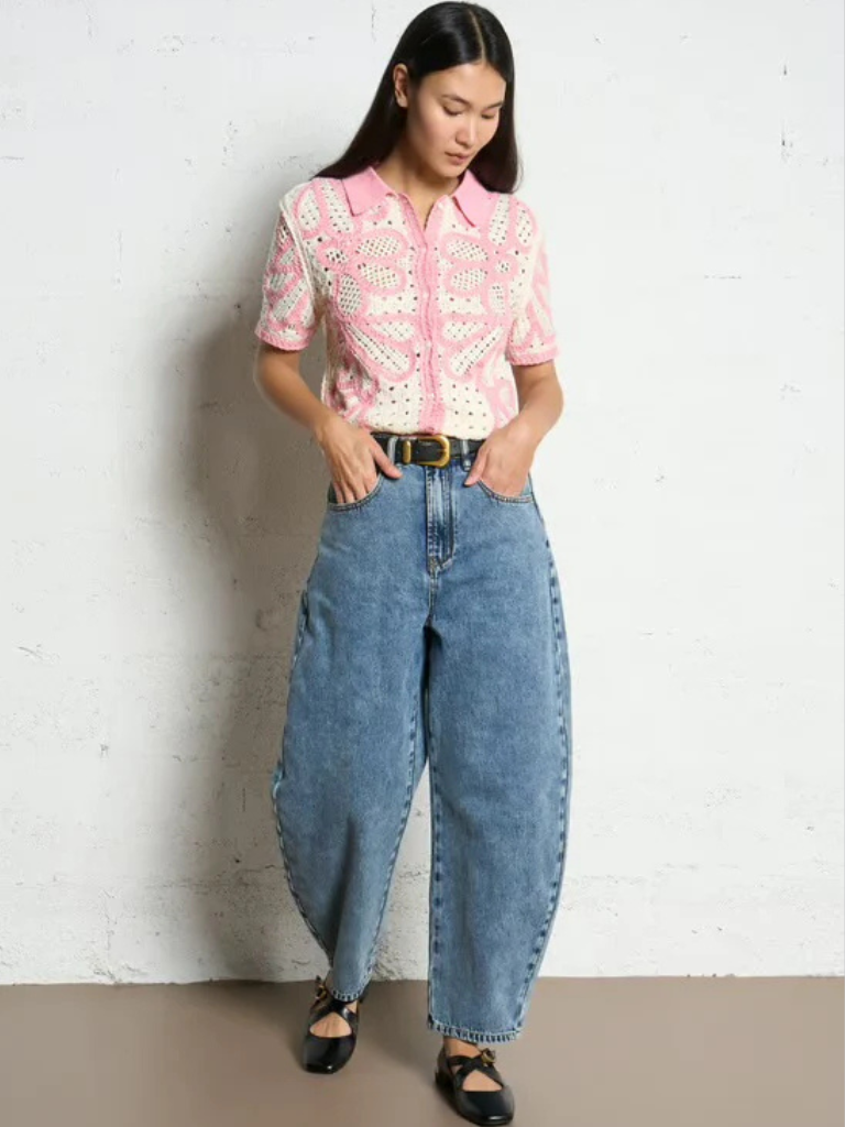 Woman in Ireland wearing colourful knitwear with collar and buttons. Paired with blue high waistd jeans. Chic Outfit