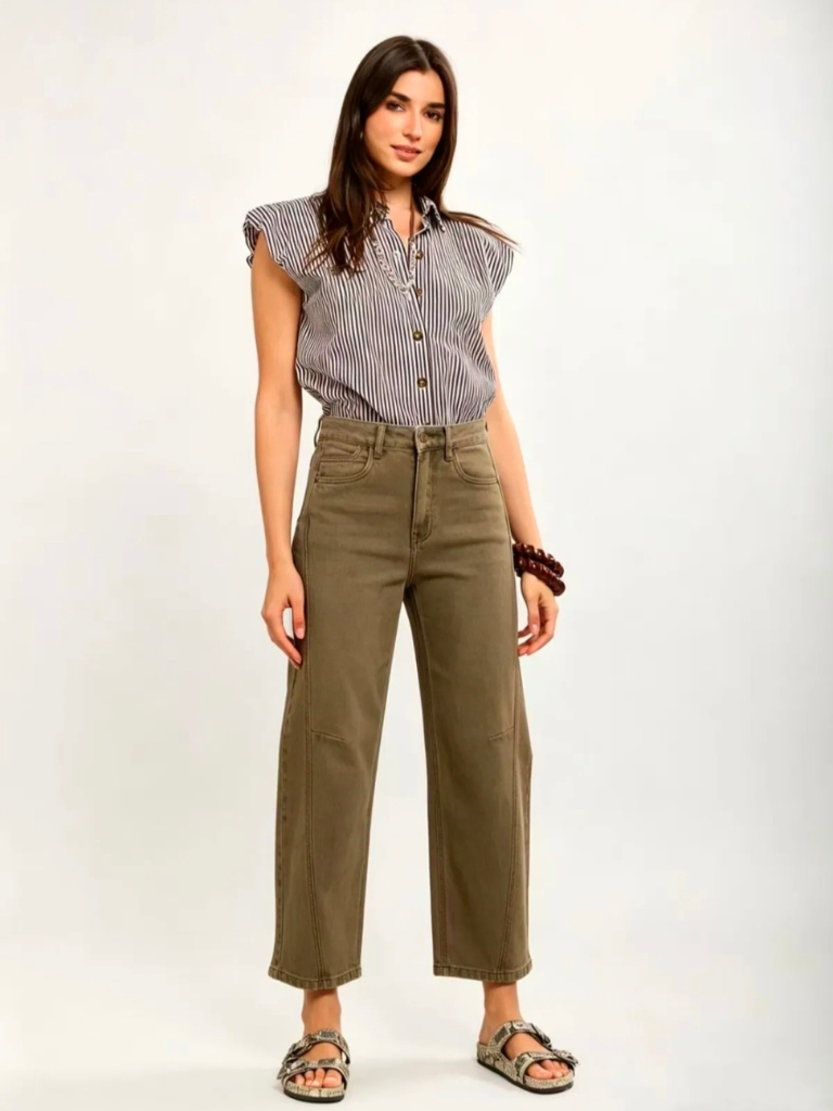 Woman in Ireland wearing green barrel leg denim jeans and chic blouse