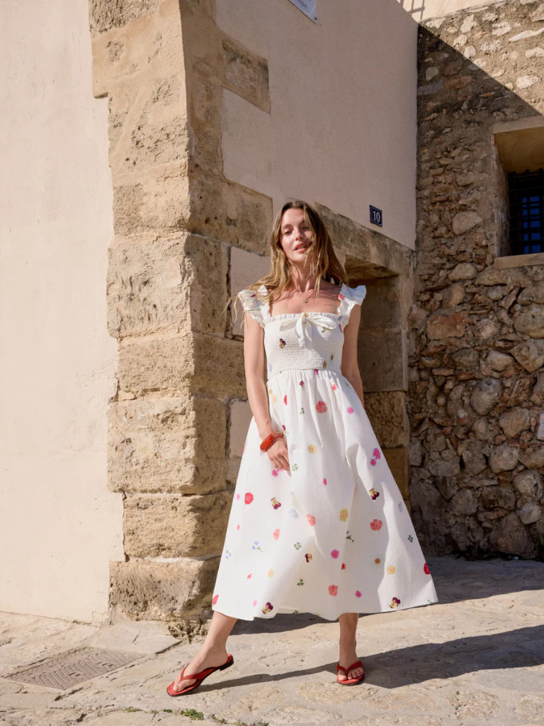 Woman in Ireland wearing cotton floral dress with pockets and colourful accessories 