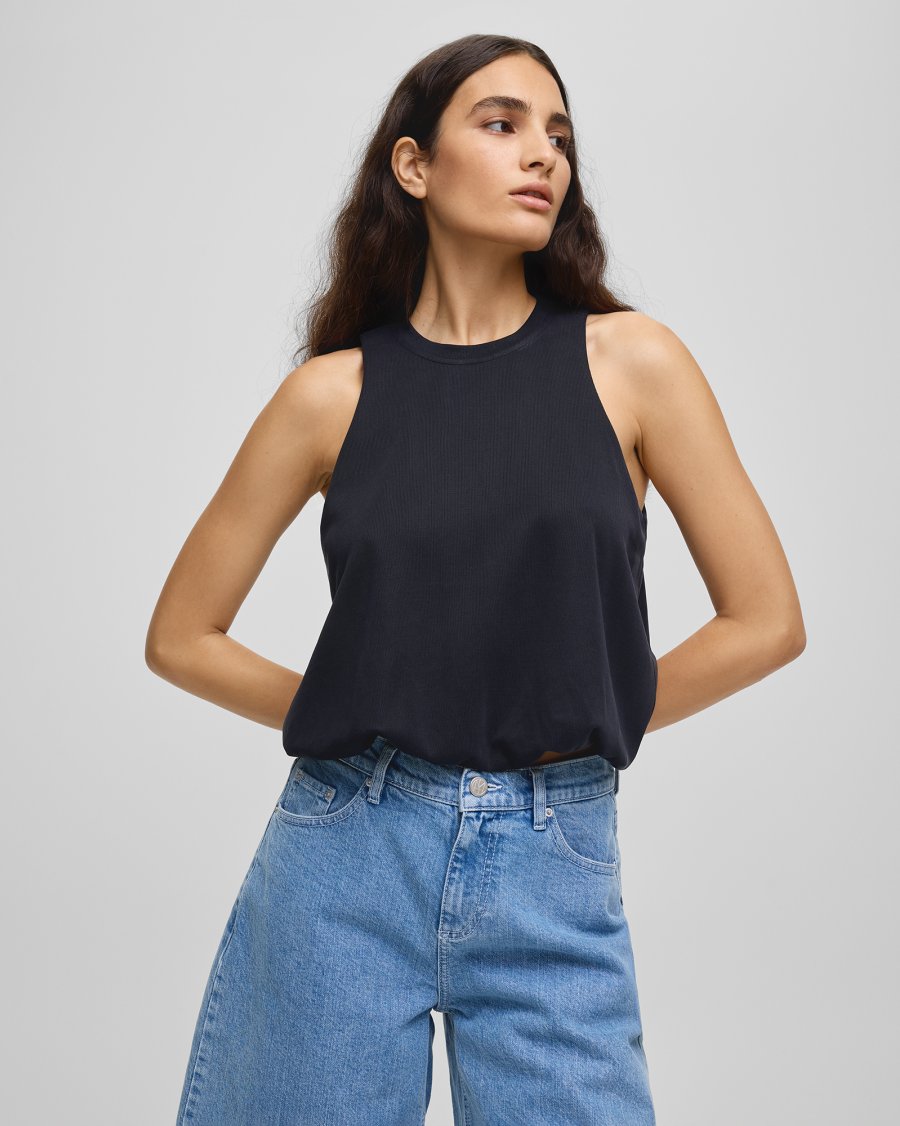 Woman in Ireland wearing a high neck cotton top scandi style with highwaisted jeans