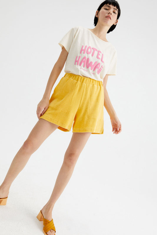 Yellow mid-rise shorts in towelling fabric